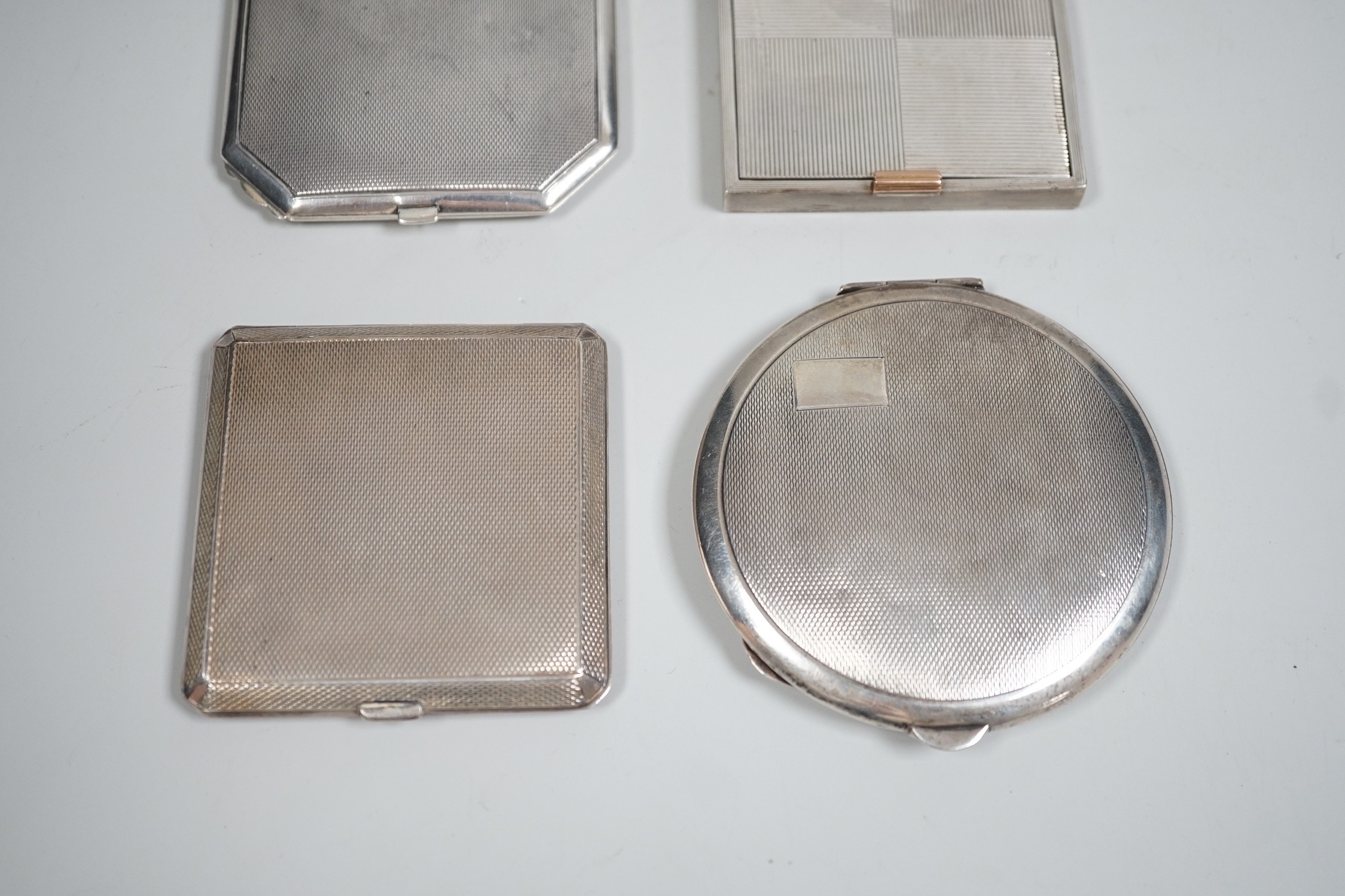 A George V Art Deco silver cigarette case, David Sutton & Sons, London, 1935, 65mm, with leather carrying case, together with three engine turned silver compacts.